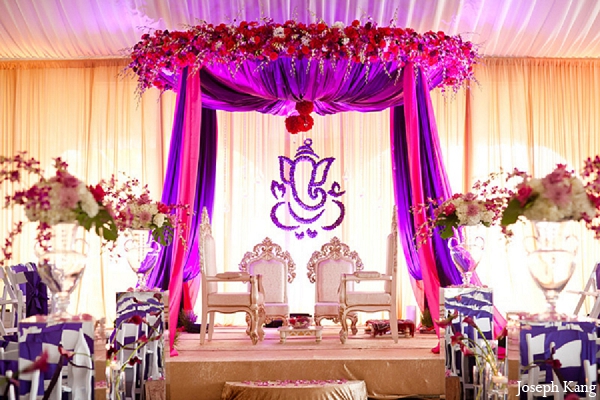 luxury indoor wedding mandap decorated with red and white flowers